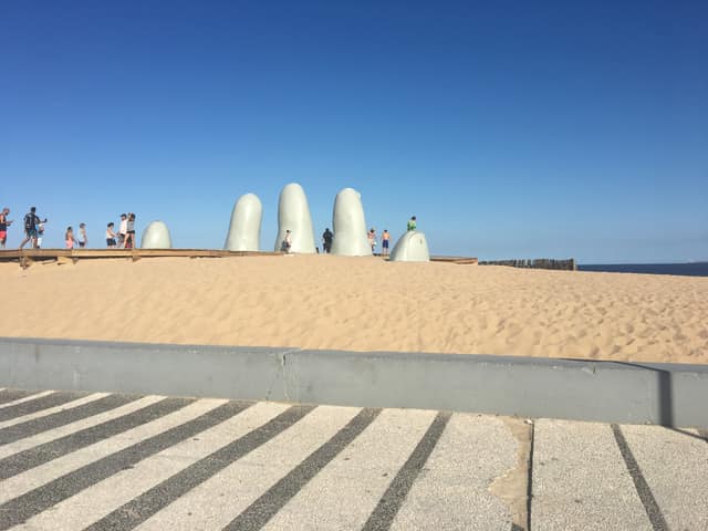 Familia junto a La Mano en Playa Brava